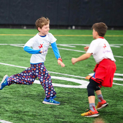 Children run on a football field as part of a Health LifeStars event.