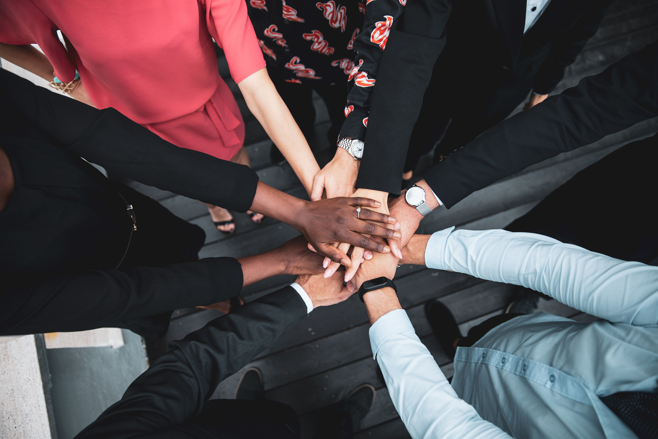 Shot of human hands stuck on each other between business colleagues partnership