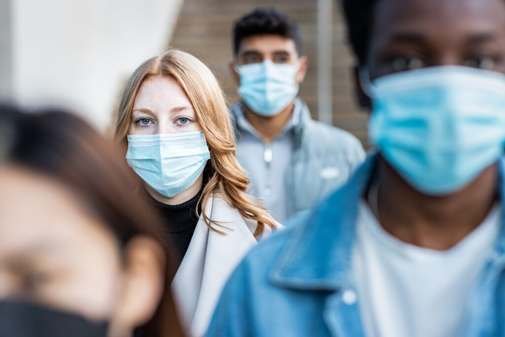 Three people wearing masks