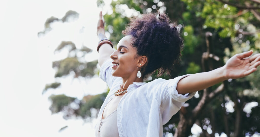 black woman with open arms, nature 