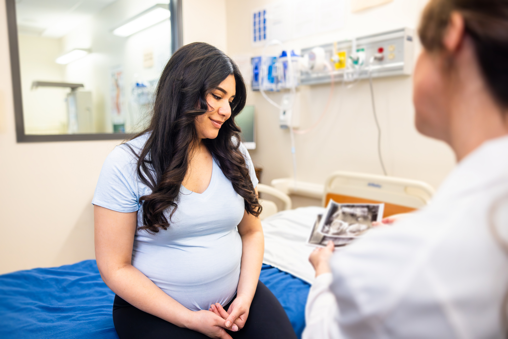 Doctor and pregnant patient at a prenatal appointment in an exam room