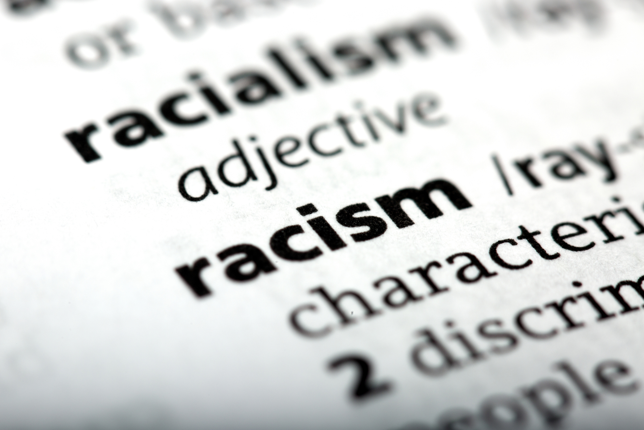 Racism is a word printed and defined in the English dictionary